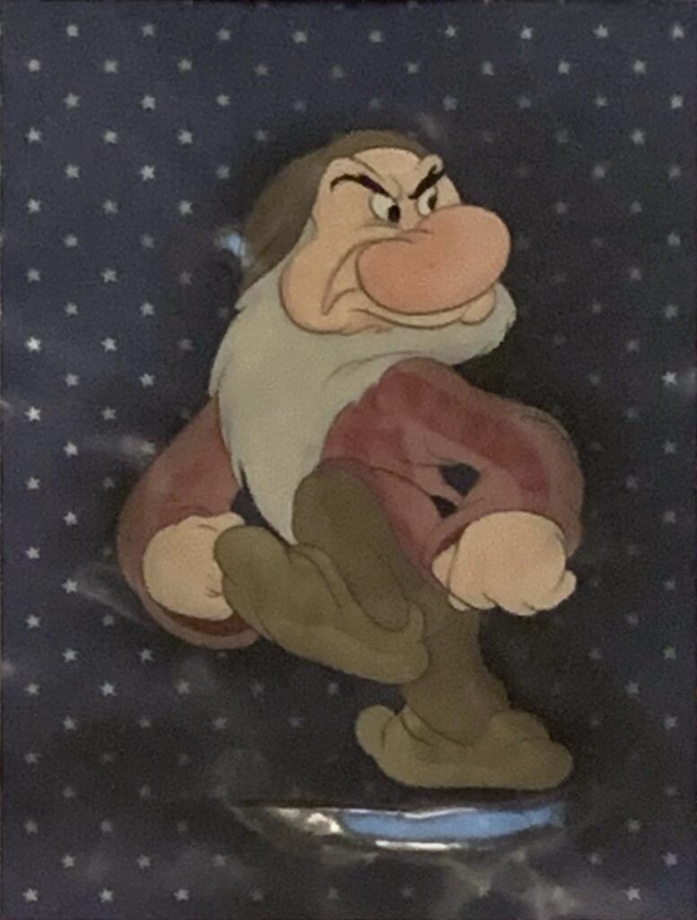 Grumpy original production cel from Snow White and the Seven Dwarfs, 1937 on a Courvoisier background.